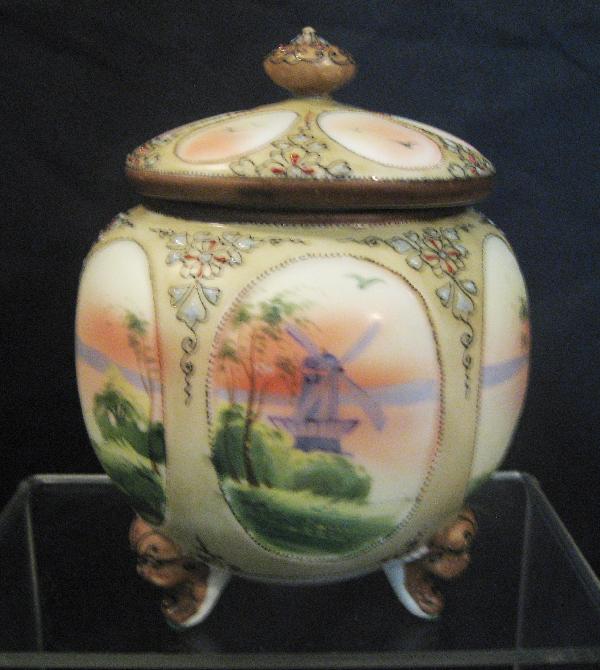 Nippon Green M with wreath footed 6-window cracker: Nippon Green M with wreath footed 6-window cracker jar with windmill scenes and raised enamel decoration. Minor rim wear.