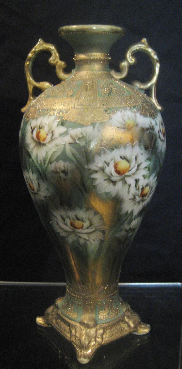 Nippon Blue maple leaf 10 3/4" floral vase with gol: Nippon Blue maple leaf 10 3/4" floral vase with gold wash ground, white florals, and gold decoration. Gold wear on handles and rim.