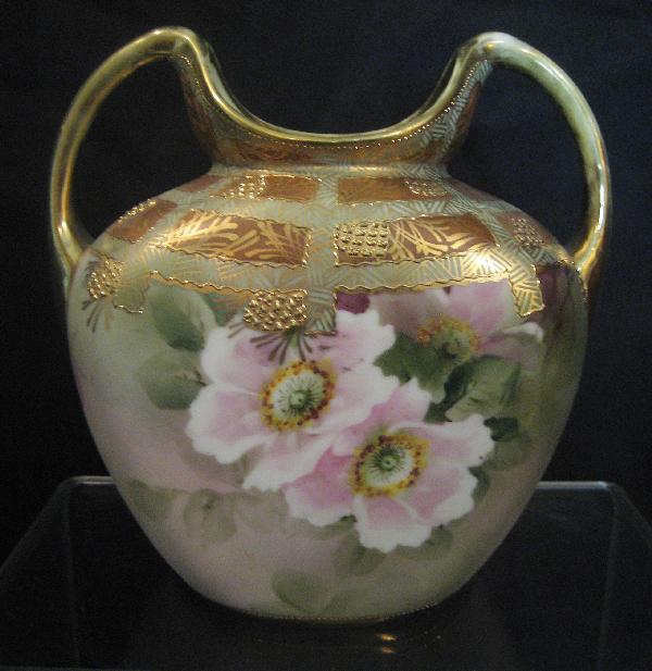 Nippon Green M with wreath 7 1/2" 2-handle vase: Nippon Green M with wreath 7 1/2" 2-handle vase with gold and dogwood decoration. Gold wear on handles.