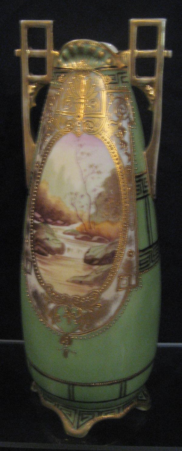 Nippon Blue M with wreath 12 1/2" 2-handle gold: Nippon Blue M with wreath 12 1/2" 2-handle gold decorated landscape vase with a flowing stream. Wear to gold handles.