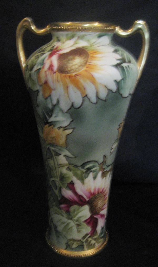 Nippon Blue maple leaf 12" satin finish 2-handle: Nippon Blue maple leaf 12" satin finish 2-handle vase with sunflower decoration and gold beading. Wear on rim.