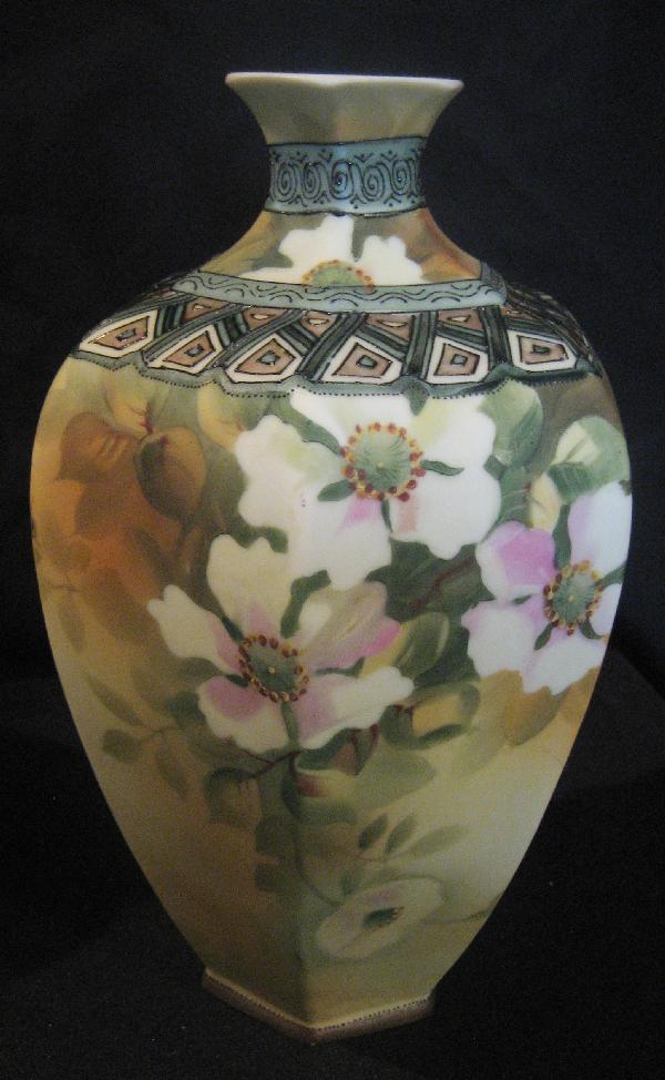 Nippon Green M with wreath 10 3/4" satin finish: Nippon Green M with wreath 10 3/4" satin finish vase with dogwood blossoms and art deco border. Minor color loss on base.