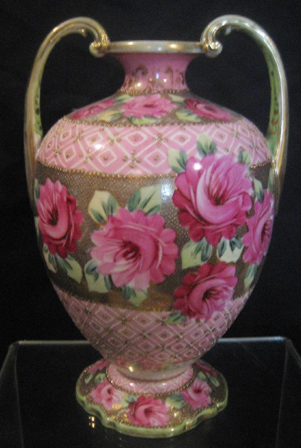 Unmarked Nippon 10 1/4" 2-handle vase with roses: Unmarked Nippon 10 1/4" 2-handle vase with roses, beaded gold center and pink ground. Gold wear on handle and rim.
