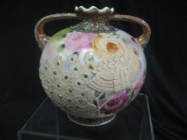 Unmarked Nippon 7" ball form handled moriage vase w: Unmarked Nippon 7" ball form handled moriage vase with peacock decoration.