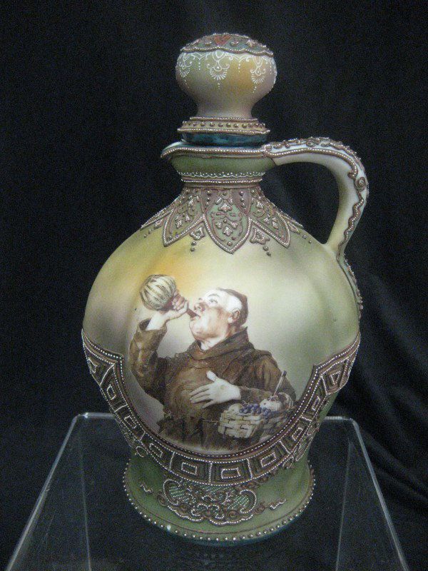 Nippon Green Maple Leaf moriage jug with monk. Si: Nippon Green Maple Leaf moriage jug with monk. Single bead missing on lower rim.