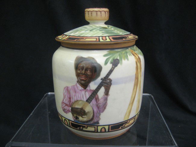 Nippon Green M with wreath humidor with a black ma: Nippon Green M with wreath humidor with a black man playing a banjo under a palm tree.