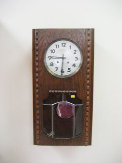 Oak case German 15-day wall clock with time and st: Oak case German 15-day wall clock with time and strike. Beveled and leaded glass lower door.