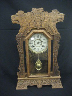 New Haven kitchen shelf clock with carved lion cres: New Haven kitchen shelf clock with carved lion crest.