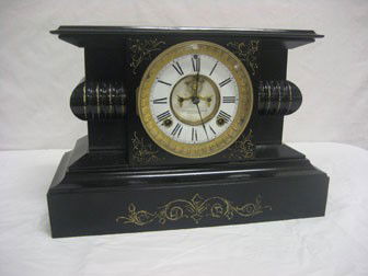 Ansonia iron mantle clock. Ebony with painted gol: Ansonia iron mantle clock. Ebony with painted gold highlights.