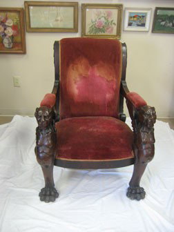 Early carved arm chair with red upholstery, massiv: Early carved arm chair with red upholstery, massive claw feet, and carved winged griffin front legs. 4" tall, 41 1/2" wide, 20 1/4" deep.