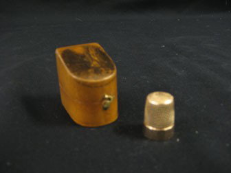 Gold thimble marked A.P. and No. 9 in a fine maple: Gold thimble marked A.P. and No. 9 in a fine maple casket with top decoration marked "The Flume, Franconia Notch, N.D.". With paper marked "For Ella".