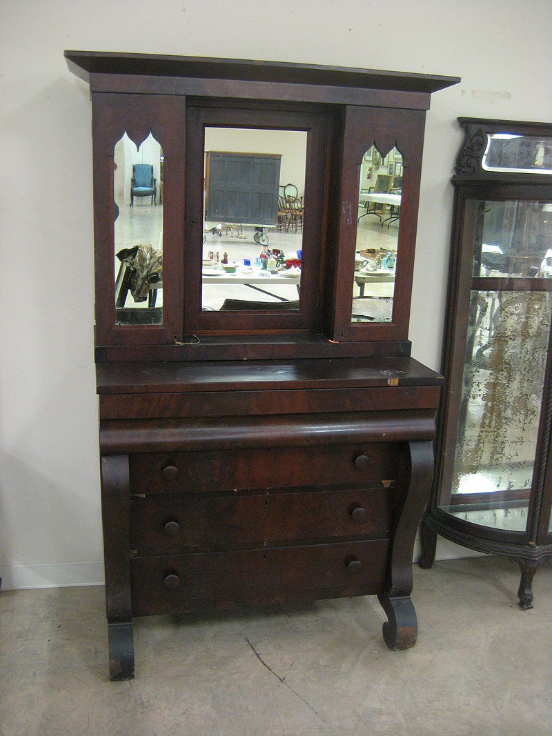 Empire two piece linen press with top with doors: Empire two piece linen press with top with doors with Gothic mirrors on each side of a center mirrored door. Expected loss and wear.
