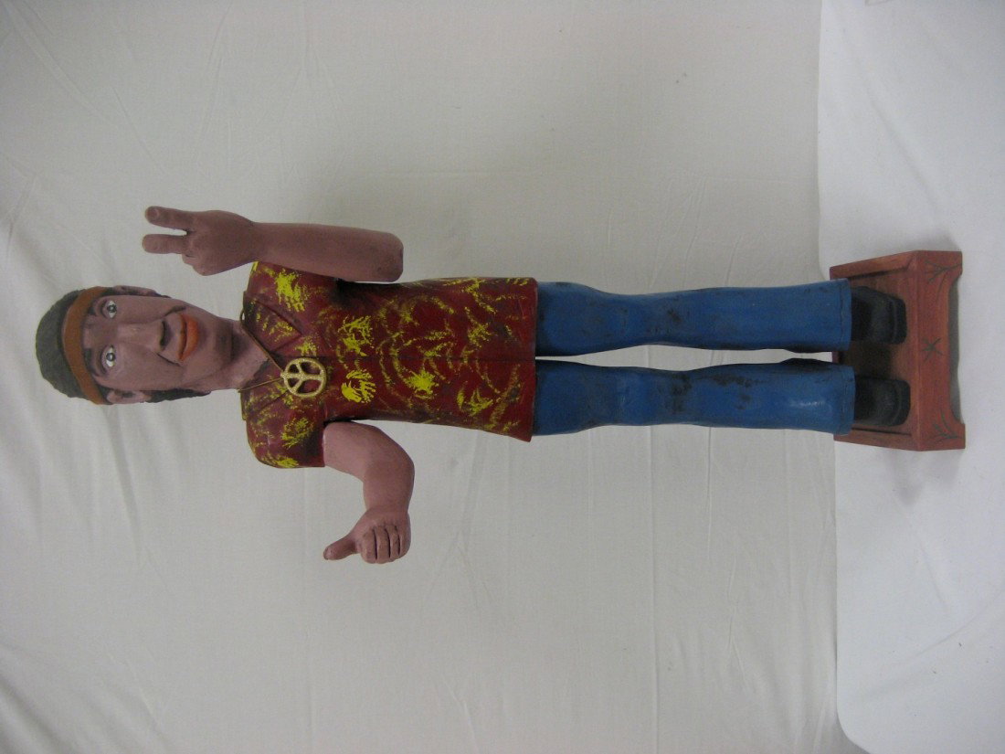 Doug Miller 43 1/2" folk art carving of a hippie e: Doug Miller 43 1/2" folk art carving of a hippie entitles "On my way to Woodstock". Dated 2-94.