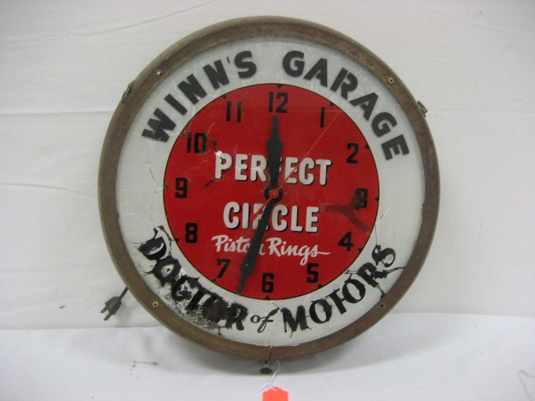Perfect Circle Piston Rings 16 1/2" clock, Winn's: Perfect Circle Piston Rings 16 1/2" clock, Winn's Garage, Doctor of Motors, with reverse painting on glass. With loss on face, repainting, frame with rust, missing 2 frame screws at front.