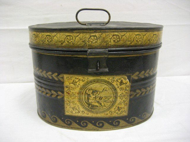 Tole painted oval hat box with paper border at top: Tole painted oval hat box with paper border at top and paper labels at front, back and sides. With hasp closer, 10 1/4" tall, 14 7/8" wide, 11 1/2" deep.