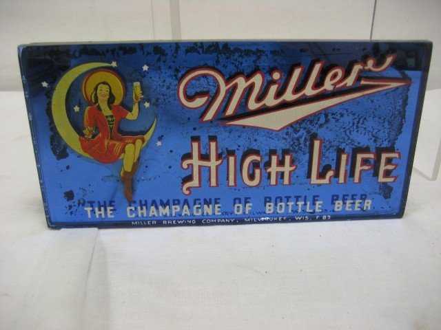Miller High Life mirrored stand up sign, The Cham: Miller High Life mirrored stand up sign, The Champagne of Bottled Beer Miller Brewing Company, Milwaukee, Wis. F83, minor loss on face, silvering loss on mirror, blue glass