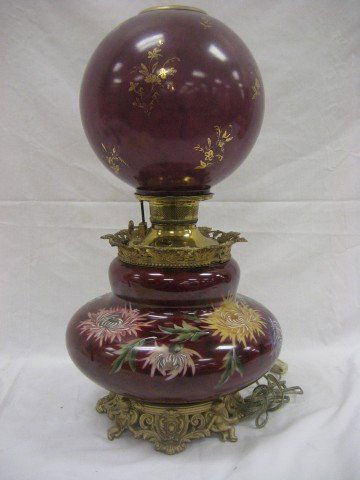22" Gone With the Wind lamp on an ornate base with: 22" Gone With the Wind lamp on an ornate base with cherub supports, Spider mum decoration, minor loss on collar.