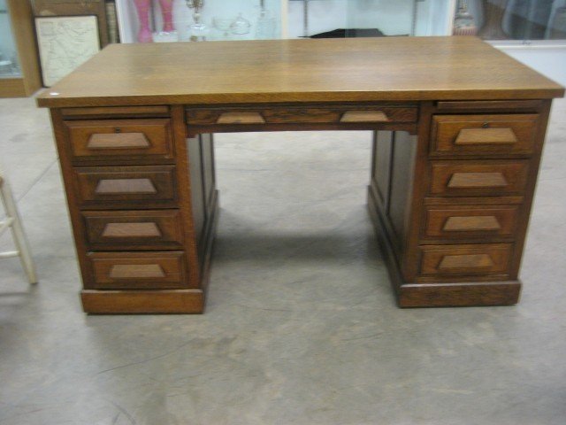 Fine oak flat top desk with nie drawers and two pu: Fine oak flat top desk with nie drawers and two pull-out writing surfaces. 30 1/4" tall, 60" wide, 34" deep, on rollers.