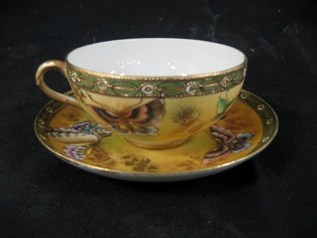 Fine Nippon cup and saucer with colorful butterfly: Fine Nippon cup and saucer with colorful butterfly and gold decoration.