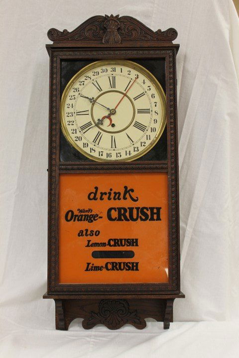 Gilbert "Observatory" eight day half hour strike ca: Gilbert "Observatory" eight day half hour strike calendar wall regulator clock with reverse painted advertising "drink Ward's Orange-Crush also Lemon-Crush Lime Crush". 15" wide, 36 1/2" tall.