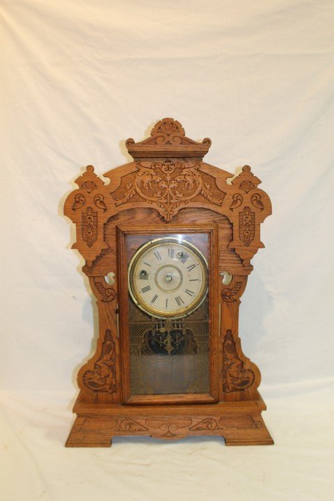Seth Thomas oak case kitchen shelf clock with carv: Seth Thomas oak case kitchen shelf clock with carved dragons. Face is detached. 25" tall, 16 1/4" wide at base