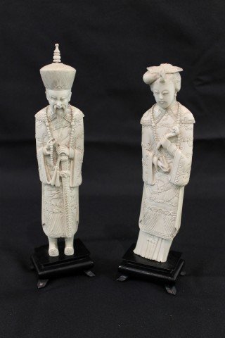 9" pair of ivory/bone carved figures on wooden bas: 9" pair of ivory/bone carved figures on wooden bases. Man is app. 9 7/8" tall at top of hat, base on lady marked Hong Kong. Height does not include base.