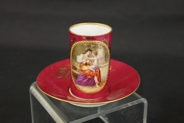Beehive mark portrait cup andsaucer with oval portrait : Beehive mark portrait cup andsaucer with oval portrait of a lady and cupid signed E. Neer. Gold and enamel decoration on a maroon background, cup is 2 7/8" tall.