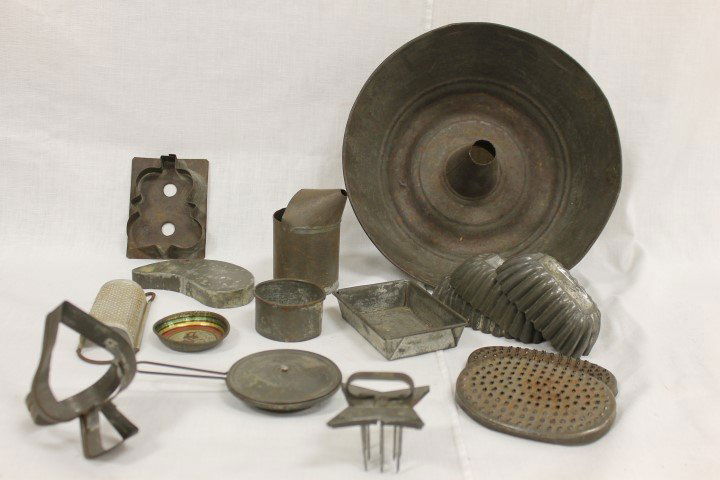 Tin items: cake pan with cookie cutters, molding pans,: Tin items: cake pan with cookie cutters, molding pans, covered toy skiller, rectangular pan with folded edges, nutmeg grater, oval graters, tin with spout, toy playe decorated with girl and dog, and 4