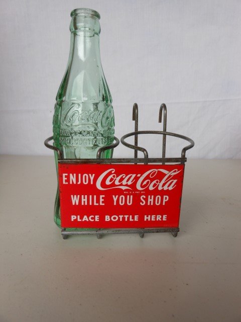 Coca-Cola 2-bottle shopping cart rack with one bottle.: Coca-Cola 2-bottle shopping cart rack with one bottle.