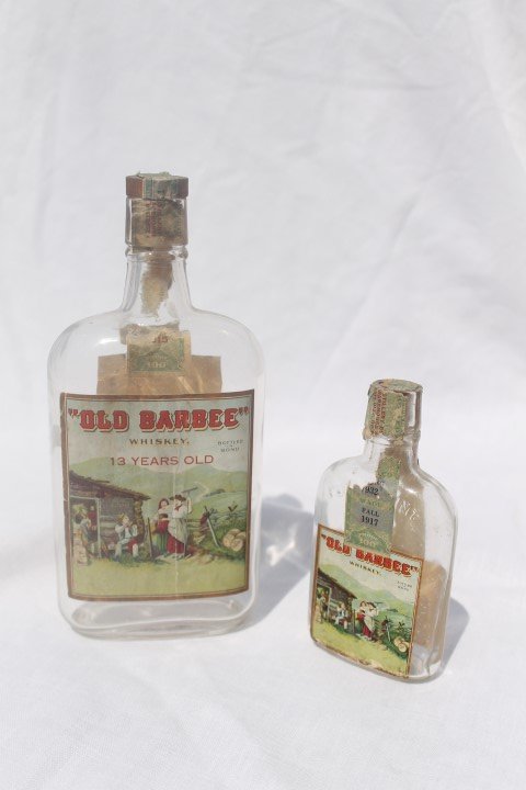 Old Barbee Whiskey: 13 Years Old pint with partial: Old Barbee Whiskey: 13 Years Old pint with partial Mayfield & Co. tag, bag with R. Lee Cassell Phamacist Lexington, KY label over Whiskey tag; 1/4 pint with partial tax stamp, some wear and loss, Midw