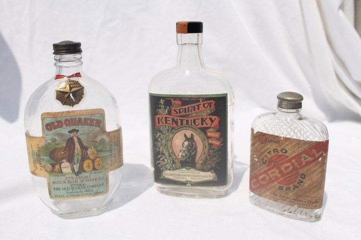Whiskey bottles: Old Quaker Straight Bourbon Whisky,: Whiskey bottles: Old Quaker Straight Bourbon Whisky, Lawrenceburg, IN, pint, embossed, mark of merit label; Spirit of Kentucky unblended bourbon, pint, embossed bottle, partial tax label; Citro Brand