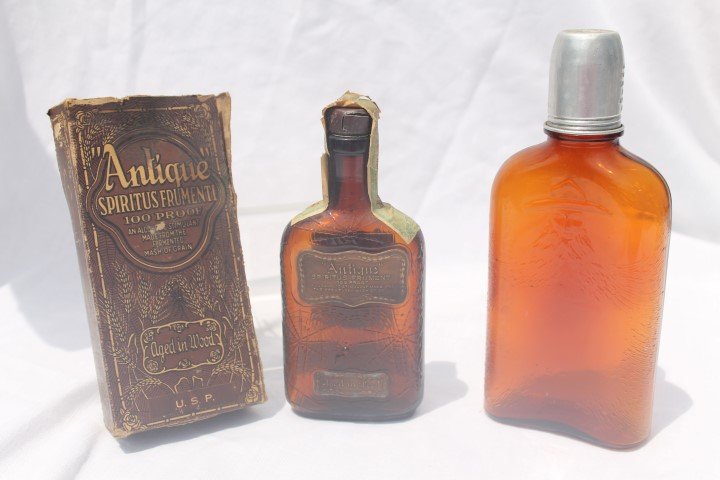 Antique Spiriters Frumenti bottle and box, amber half: Antique Spiriters Frumenti bottle and box, amber half pint, Frankfort Distillery Co., tax stamp, back labels; amber pint, embossed man with beard