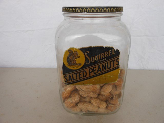 Squirrel Brand Salted Peanuts jar, 9 1/4" X 5 1/2": Squirrel Brand Salted Peanuts jar, 9 1/4" X 5 1/2". Crack in jar.