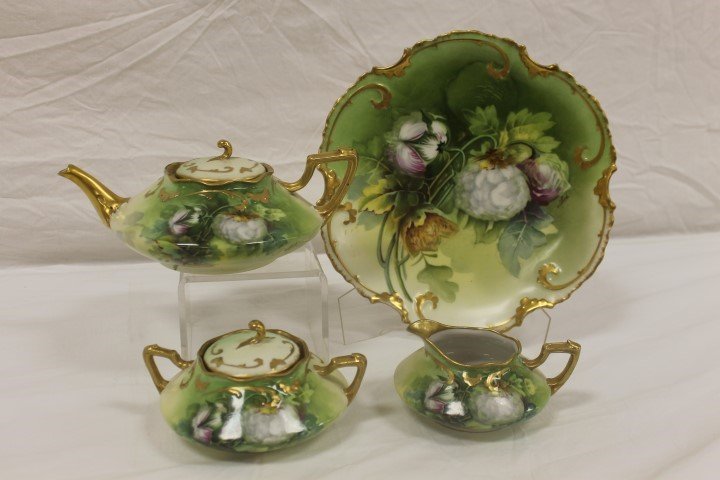 Limoges tea set decorated in the King Cotton pattern,: Limoges tea set decorated in the King Cotton pattern, an exclusive design signed by Albert at the Pitkin & Brooks Studio, Chicago. Plate is 9 1/2". Minor gold wear, rim nick on sugar.