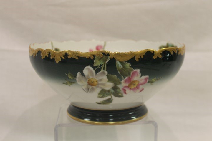 T&V Limoges 9 1/2" pedestal punch bowl with floral: T&V Limoges 9 1/2" pedestal punch bowl with floral decoration and gold trim on a white shaded to green background. 4 3/8" tall