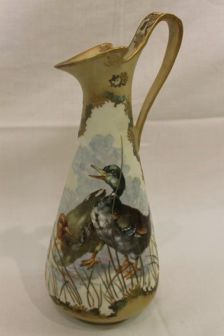 Exceptional 12 1/2" Pairpoint Limoges ewer with Guba: Exceptional 12 1/2" Pairpoint Limoges ewer with Guba duck and raised floral and reed decoration. Minor loss on reeds. 2015 43