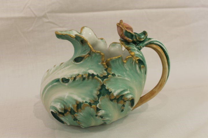 Rare Pairpoint Limoges 6 3/4" cabbage leaf form pitcher: Rare Pairpoint Limoges 6 3/4" cabbage leaf form pitcher with rose tipped leaf and vine handle. App. 10" wide from front to handle, with gold trim. Some wear and color variation.