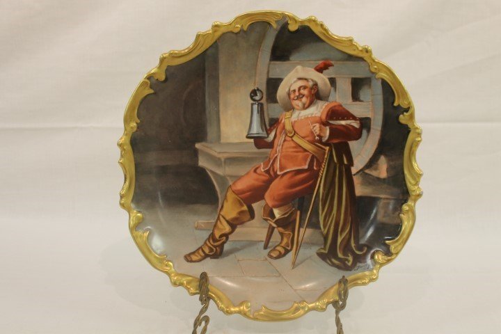 Blakeman & Henderson Limoges 12 3/4" charger with a: Blakeman & Henderson Limoges 12 3/4" charger with a seated Cavalier, signed Baumy. Gold border with minor wear, minor surface scratching.