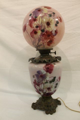 Gone With the Wind lamp with floral decorated base and: Gone With the Wind lamp with floral decorated base and shade on an oak leaf and acorn base. App. 25" tall, with a ball shade app. 10" wide. Minor loss on the fitter rim of the shade, some damage to th