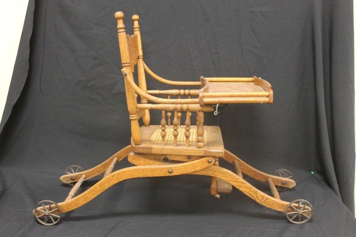 Oak pressed back convertible stroller/high chair with: Oak pressed back convertible stroller/high chair with cane seat. Little Jack Horner pressed into the back. Minor separations in the wood.