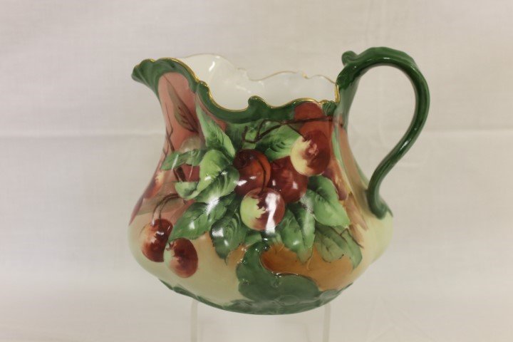 T&V Limoges France 7 1/2" milk/cider pitcher decorated: T&V Limoges France 7 1/2" milk/cider pitcher decorated with cherries, with gold trim.