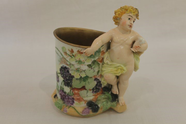 Rare Martial Redon Limoges large mug with applied: Rare Martial Redon Limoges large mug with applied figural cherub handle, molded leaves, vines and berries, and blackberry decoration. 7" tall, with a broze painted interior. C. 1872