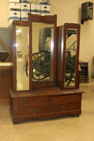 Oak deep well gentleman's dresser with four drawer base: Oak deep well gentleman's dresser with four drawer base with ornate brass pulls and shell carved apron. Mirrored left cupboard with upper shelf and hooks for hanging; mirrored right cupboard with shel