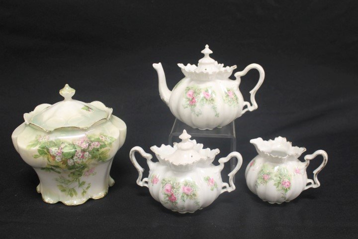 Red mark R.S. Prussia: lustre finish 8-lobe cracker: Red mark R.S. Prussia: lustre finish 8-lobe cracker jar with floral decoration, finial re-attached on lid; tea set with floral decoration with minor rim nick on tea pot, restoration on creamer, and su