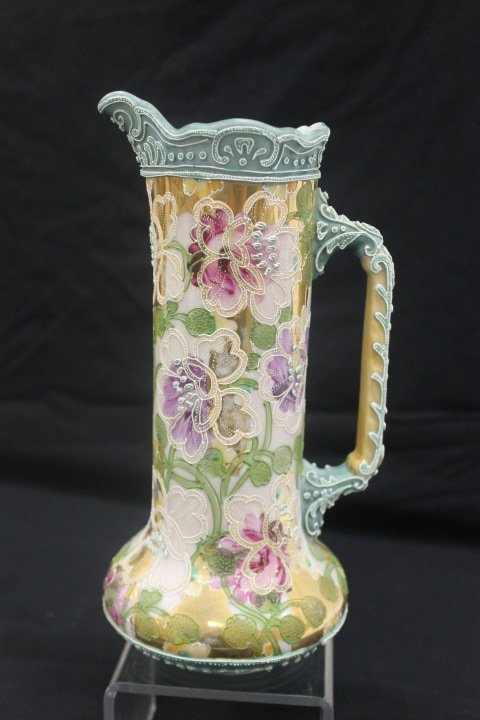 10 1/4" moriage decorated unmarked Nippon tankard with: 10 1/4" moriage decorated unmarked Nippon tankard with floral decoration on a heavy gold background. Small section of loss on base.