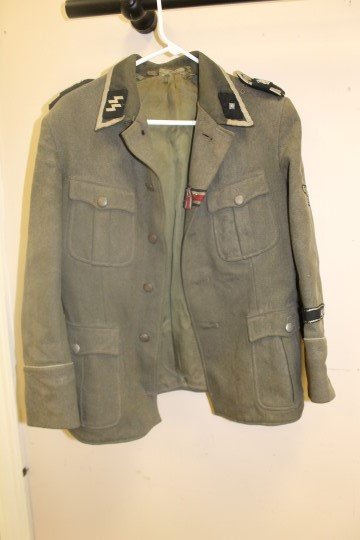 World War II German SS Waffen jacket with expected wear: World War II German SS Waffen jacket with expected wear and loss. Marked "dedoronhallig NVA 108 75445 K 48 1802 111 3"