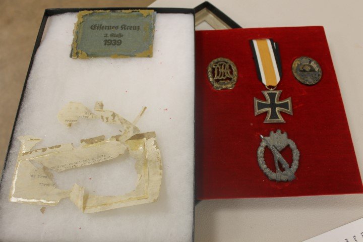 Group of four German World War II medals with paper: Group of four German World War II medals with paper fragment stating they were surrendered at Stalingrad. World War II Iron Cross, dated 1813 and 1939, with partial envelope; SS Wehrmocht infantry med