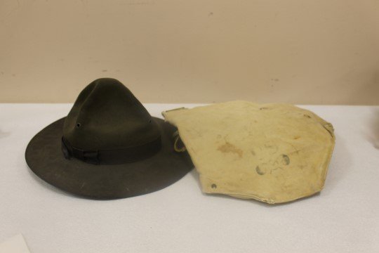 World War II Drill Instructor's hat with band and chin: World War II Drill Instructor's hat with band and chin strap, with World War II gas mask holder. Hat is app. 14' long, 12 3/4" wide, app. 7" tall. Gas maks holder has a faint mark "MTV LOT P2-2" and "