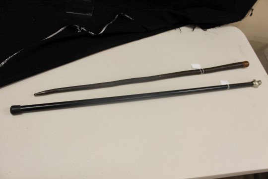(2) WW2 era German Nazi office canes. One is a leather: (2) WW2 era German Nazi office canes. One is a leather cane with a party symbol inset in top, app. 35". Second is a German army WW2 Reserve can with silver type head, with plating showing some wear, a