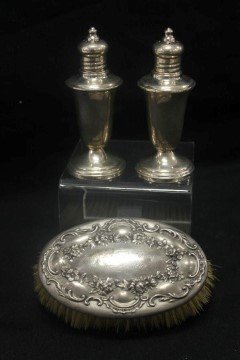 Sterling silver Crown salt and pepper shaker set with: Sterling silver Crown salt and pepper shaker set with weighted base, with floral embossed 4 3/4" oval brush engraved "James Cullen Russell June 9, 1899".